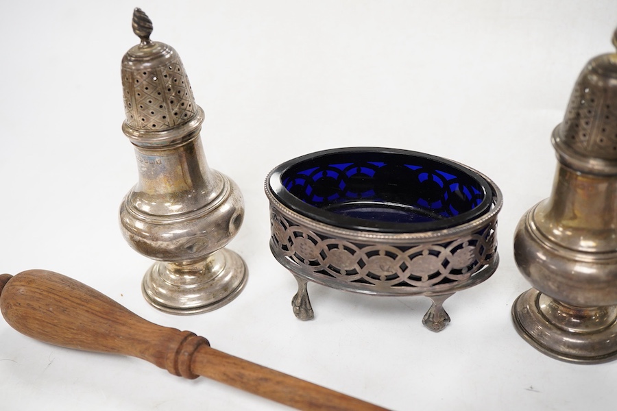 Sundry silver, consisting of - a pair of pepper pots, Birmingham, 1948 a pair of George III pierced oval salts, with blue glass liners and a modern silver candle snuffer with a turned wood handle.